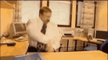 a man in a white shirt and tie is standing in a room