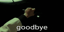 a car is driving down a road with the word goodbye written on the ground