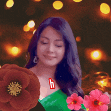 a woman in a green dress is surrounded by flowers with the letter h on her chest