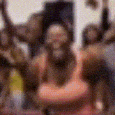 a blurry picture of a group of people standing next to each other with their arms in the air .