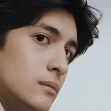 a close up of a man 's face with a serious look on his face