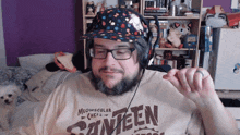a man wearing headphones and a shirt that says canteen