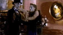 a man in a top hat and bow tie is holding a woman 's hand .
