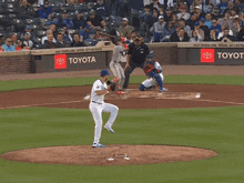 a baseball game is being played in front of toyota advertisements