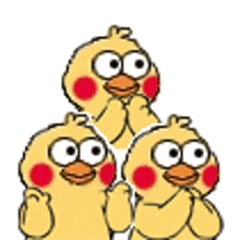 three yellow chickens with big eyes and red cheeks are standing next to each other .