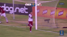 a soccer game is being played in front of an advertisement for dognet