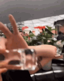 a close up of a person 's hand holding a glass