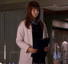 a woman in a lab coat holding a clipboard