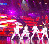 a group of people are performing on a stage with a sign that says bizness