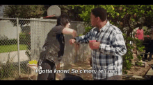 a man in a plaid shirt says i gotta know so c'mon tell me while another man holds a cup of coffee