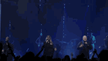 a man singing into a microphone with the words " i breathe you out " above him