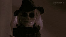 a skeleton holding a knife in a dark room with shrinkeefx written in the corner