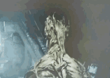 a close up of a monster 's back in a dark room with smoke coming out of it 's mouth .
