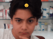 a boy with a yellow smiley face on his forehead