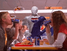 a group of people are sitting at a table with pepsi cans on it