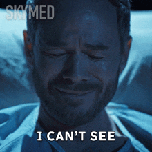 a man in a hospital bed with the words i can 't see written below him