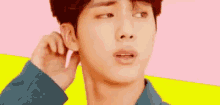 a close up of a person 's face with a pink earring in their ear .