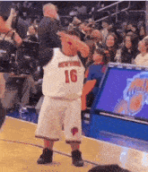 a basketball player with the number 16 on his jersey is dancing