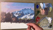 a painting of a snowy mountain landscape is being painted