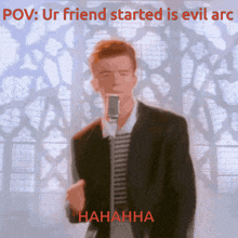 a man singing into a microphone with the words pov ur friend started is evil arc behind him