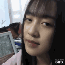 a close up of a girl 's face with the words made with gifx on the bottom