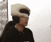a person wearing headphones has a hand on their face
