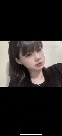 a young girl is taking a selfie with her phone .