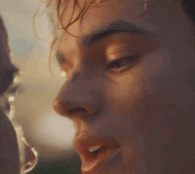 a close up of a woman 's face with water coming out of it .