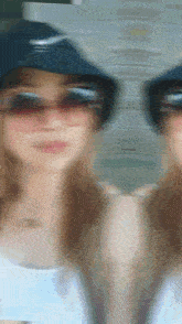a blurry picture of a woman wearing sunglasses and a hat