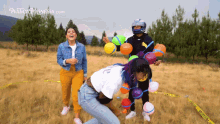 a group of people are playing with water balloons in a field with the website plasticapolynesia.com
