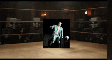a man in a suit is standing in a boxing ring with a ball