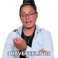 a woman wearing glasses and a denim jacket says that she has feelings