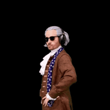 a man in a brown coat and tie is holding a small figurine
