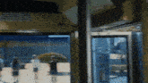 a blurry picture of people walking in front of a glass door