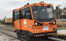 an orange train with the number 16 on the front of it