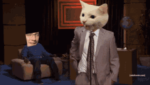 a man sitting on a couch with a cat on his head and adult swim.com in the corner