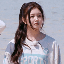 a girl wearing a white shirt that says ports