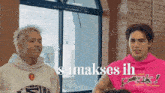 two men are standing next to each other and one of them is wearing a pink hoodie that says pinky