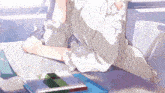 a girl sits at a desk with a stack of books including one that says 0