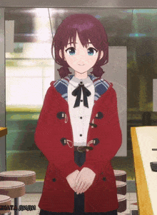 a girl in a red coat is standing in front of a sign that says hata diidi