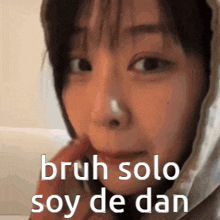 a close up of a woman 's face with the words bruh solo soy de dan on the bottom