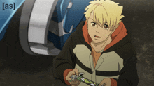 a boy is holding a remote control in front of a car and the word [ as ] is on the bottom