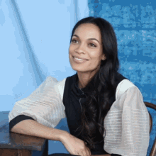 rosario dawson interview black and white outfit blue background