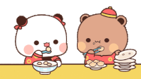 two teddy bears are sitting at a table eating food