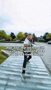 a man with grey hair is rapping faster than eminem and better than finna
