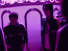 a man with the number 8 on his shirt stands next to another man