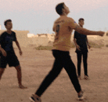 a man in a yellow shirt with the number 1 on the back is throwing a ball