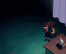 a person is sitting in a chair in a dark room next to a table