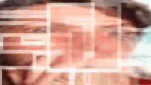 a blurry picture of a man 's face with a grid of squares surrounding it