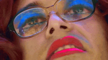a close up of a woman wearing glasses and pink lips
